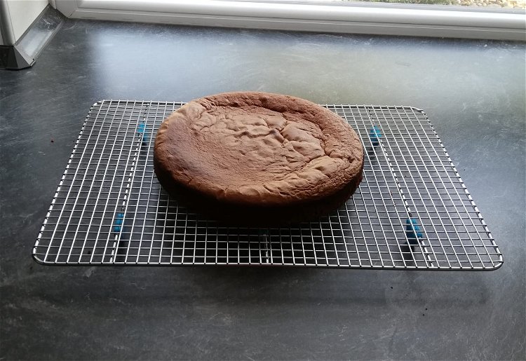 Image of Pour the sponge cake into the prepared pan, smooth it...