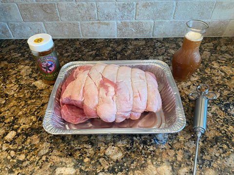 Image of Inject your pork evenly with the apple mixture 