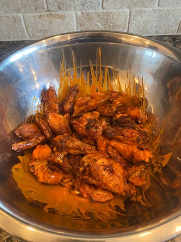 Image of Place wings into a large bowl and pour buffalo sauce...