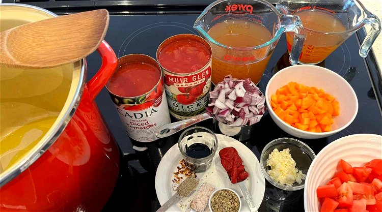 Image of Add the tin of tomatoes, fresh tomatoes, balsamic vinegar &...