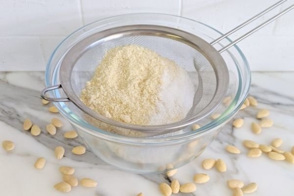 Image of Sift together almond flour, sweetener & baking powder.