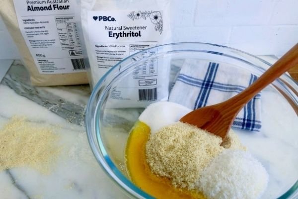 Image of Mix together the almond flour, coconut, melted butter, erythritol, and...