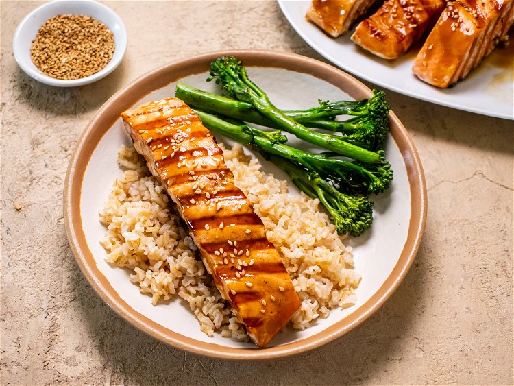 Image of Serve salmon hot brushed with remaining teriyaki sauce and sesame...