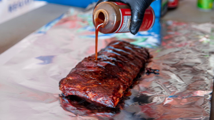 Image of Transfer ribs to foil pack and pour in 1/4 cup Blues Hog Tennessee Red. Cook until the ribs tender and have bones showing on the ends. 