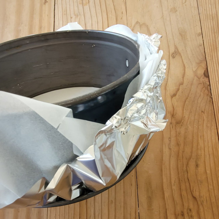 Image of Springform 18 cm mit Alufolie und dann mit Backpapier auslegen. Die Folie so gross, dass du gut einen hohen Rand aussen um die Springform hochziehen kannst. Es verhindert, dass dir die flüssige Creme aus der Form Läuft