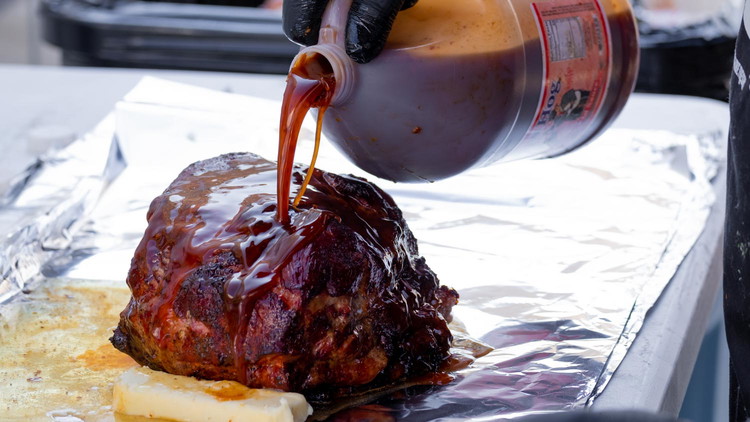 Image of Halfway through cooking, wrap the pork in foil, cover with a cup of Tennessee Red, and return to the smoker.