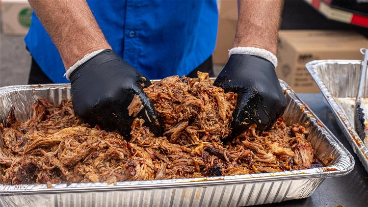 Image of Using hands, forks, or tongs, start pull the pork apart....