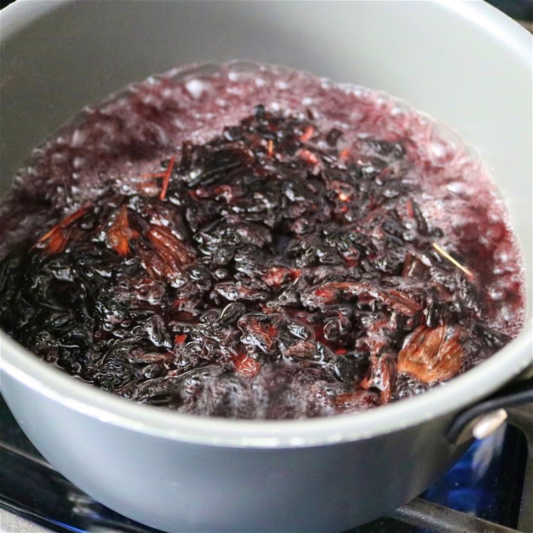 Image of Once boiling, add hibiscus flowers and allow to boil for...