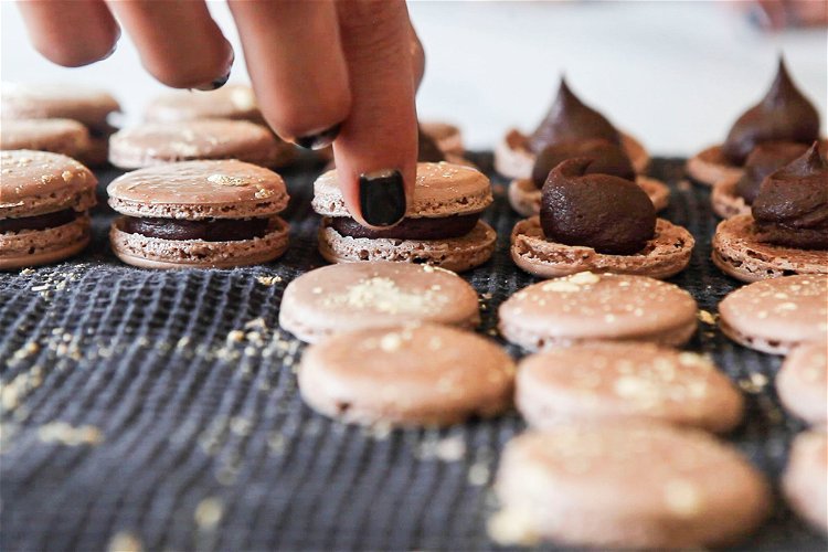 Image of Pipe the ganache onto half the macaron shells. Try to...