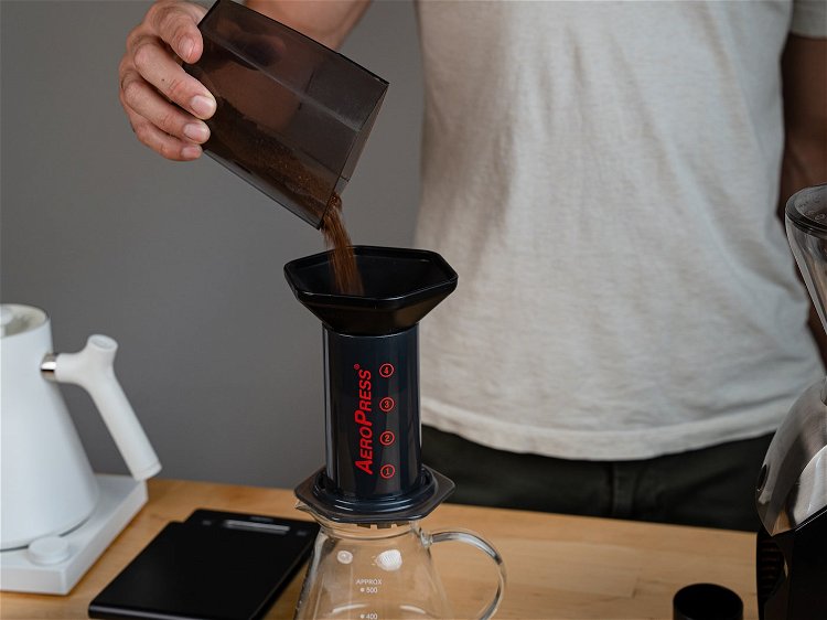 Image of Take your coffee and pour it into the Aeropress. The...