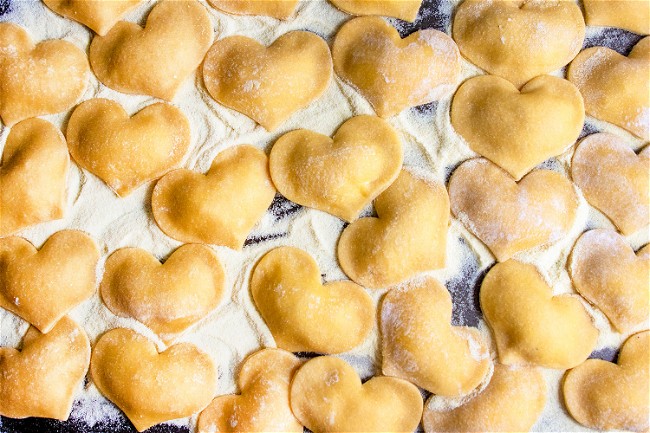 Image of Heart-Shaped Cheese Ravioli In Pink Sauce