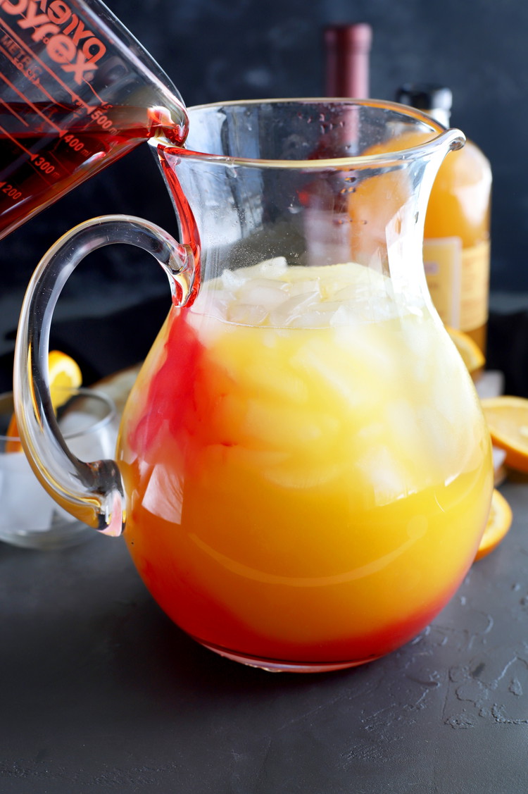 Image of Slowly pour Stirrings Grenadine into the pitcher so it sinks to the bottom.