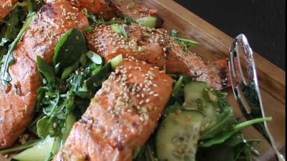 Image of Tea Marinated Cedar Salmon over Sesame-Honey Greens