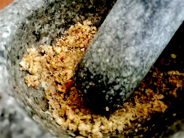 Image of In the mortar, add a pinch of salt, pepper, and...