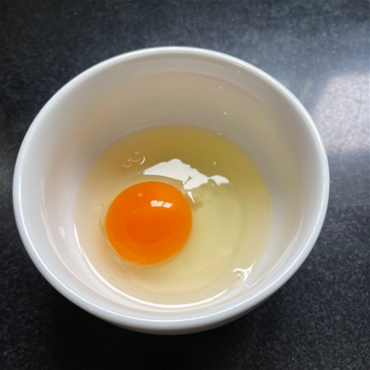 Image of Crack the egg into a small bowl while preparing water....