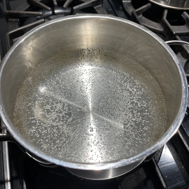 Image of Place water and vinegar into a pot. Turn on high...
