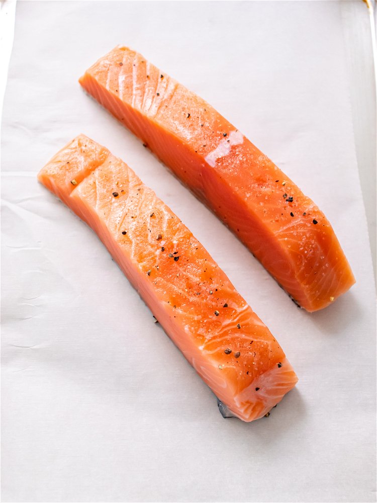 Image of Seasoning salmon with salt and pepper and spray lightly with...