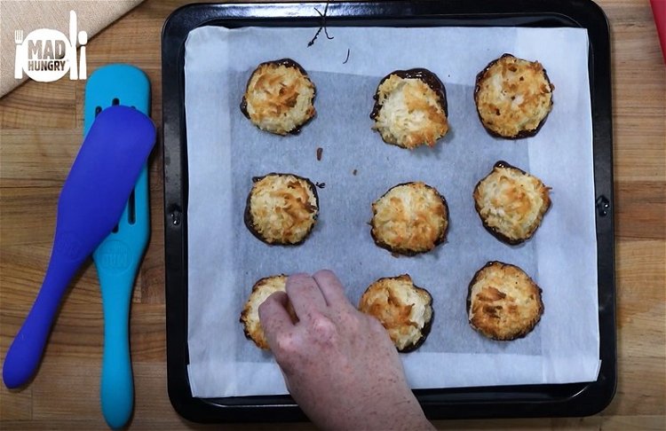 Image of One at a time, carefully dip each macaroon bottom first...