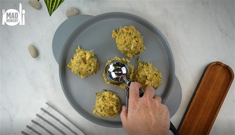 Image of Using an ice cream scoop, portion out your fish cakes...
