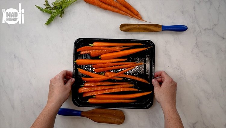 Image of Add sliced carrots to another baking tray lined with parchment....