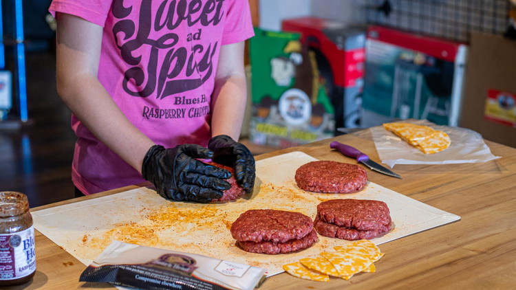 Image of Cutting colby jack slices into quarters, place your desired amount of cheese on 4 of the patties. Take the other patties and lay one on top of each cheese stacked patty. Pinch the sides together and shape into one large...