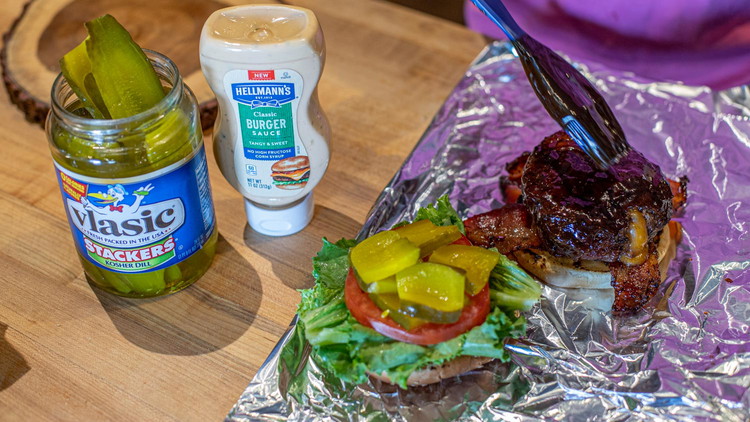 Image of When everything is ready, transfer burgers to the bottom buns and top with bacon, lettuce, tomato, pickles, and mayo.