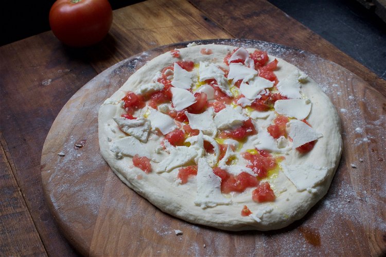 Image of 5. Distribute crushed tomatoes over top of dough and then...