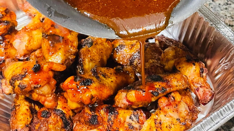 Image of Remove from heat and use a large bowl to toss the grilled wings the sauce mixture. 