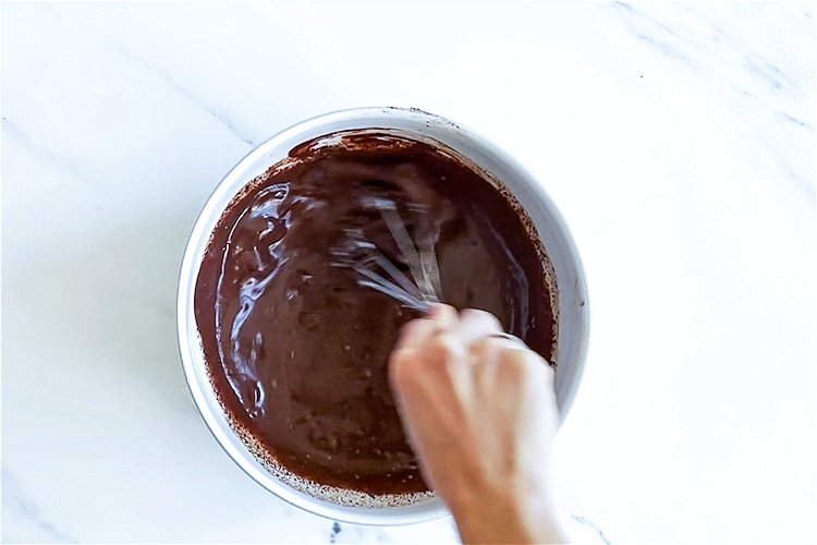 Image of Pour the chocolate filling into the baked base and smooth...