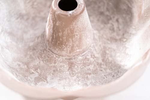 Image of Lightly grease your Bundt cake pan and dust it with...