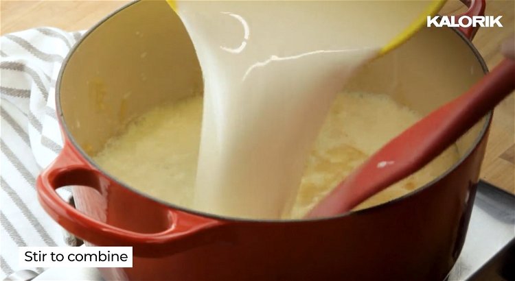 Image of Whisk in warmed milk and garlic powder, continuing to stir...
