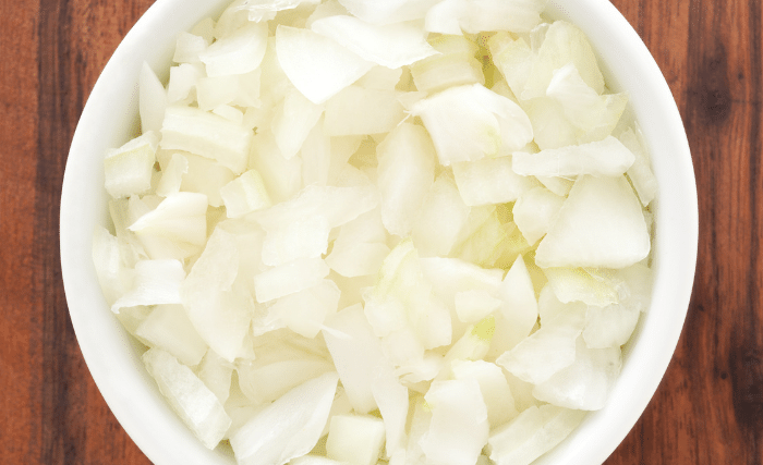 Image of Add a garlic clove and ½ tablespoon of diced onions...