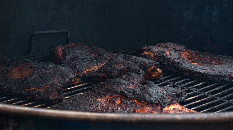 Image of Smoke at 300º for approximately 4 hours. Halfway through cooking, wrap in foil, cover with a cup of Tennessee Red, and return to the smoker. The pork should be done when the skin is tough and the meat is tender. 