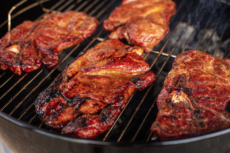 Image of After your steaks have beautiful grill marks, move your pork steaks to indirect heat and slather in Smokey Mountain Barbecue Sauce. Let your pork steaks finish cooking for another 10-15 minutes or until the pork reaches an internal temperature of...
