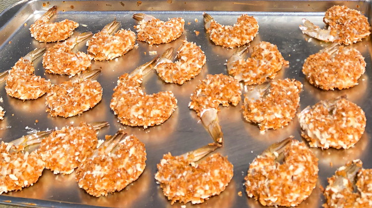 Image of Dip
     shrimp in flour dredge, milk dredge and coconut dredge and lay onto
     parchment paper pan. 