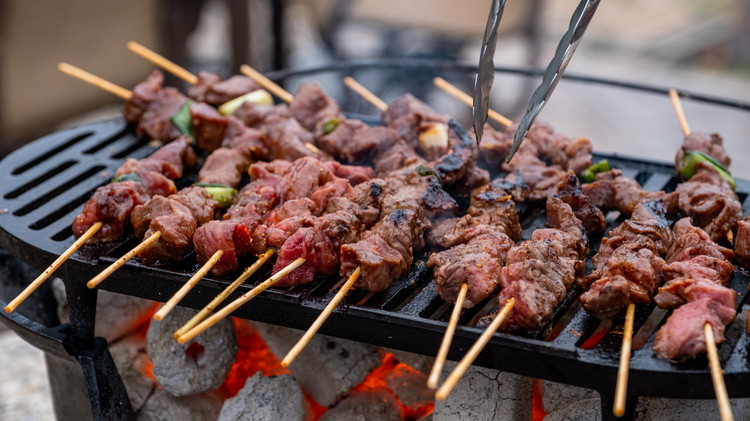 Image of After cleaning and greasing the grill, place the skewers on the direct heat. Use tongs to flip the skewers, giving 1-2 minutes on each side. 