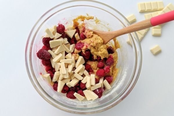 Image of Gently fold through the chopped white chocolate and raspberries.