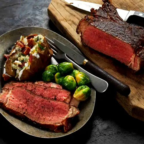 Image of Grilled Cowboy Steak with Loaded Baked Potato and Brussels Sprouts