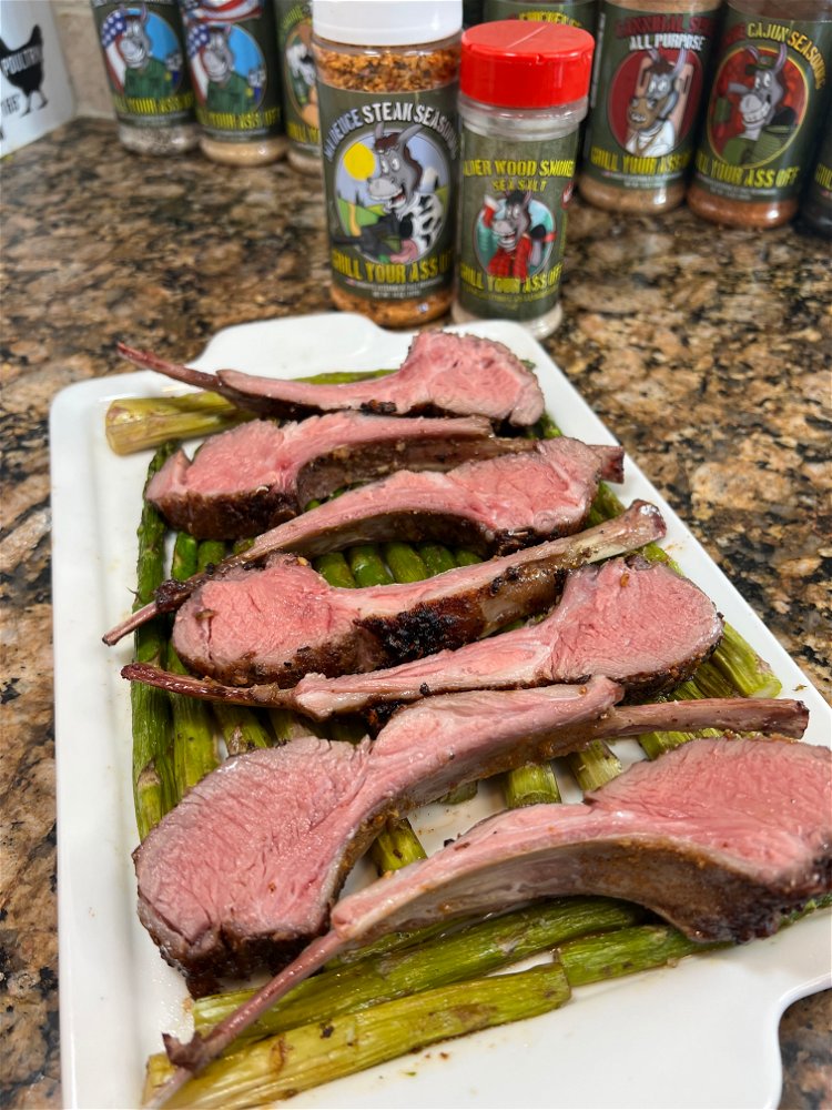 Image of Place the Lamb Chops on a bed of asparagus 