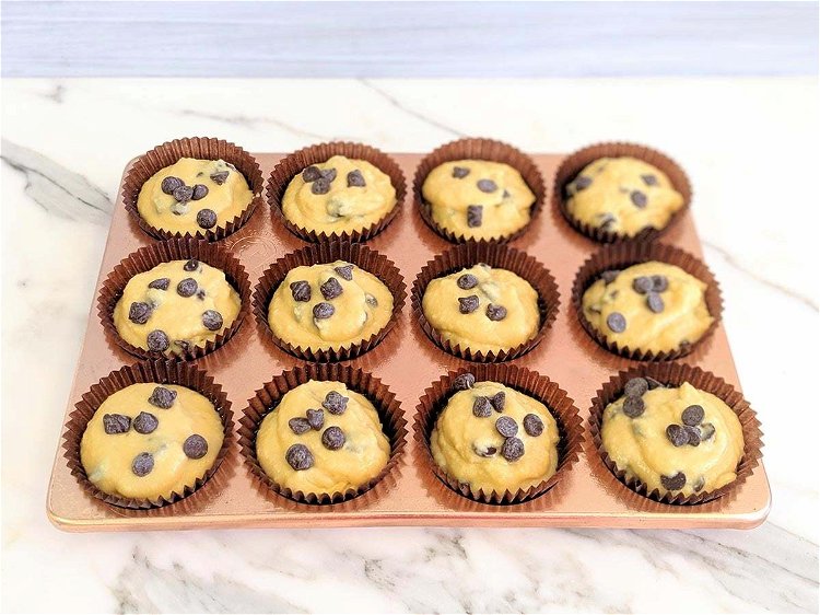 Image of Portion out the mix evenly into the cupcake cases.(optional -...