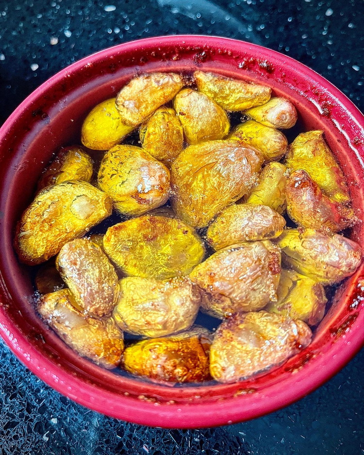 Image of Add garlic, olive oil and a pinch of salt into an oven proof ramekin, then cook at 150C/302F for 60 mins or until garlic cloves or soft like butter. Allow confit garlic to cool