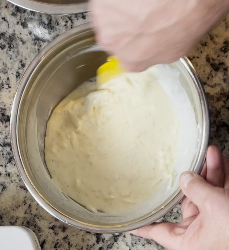 Image of In a mixing bowl, combine eggs, ricotta, sour cream, and baking powder. Whisk to combine.