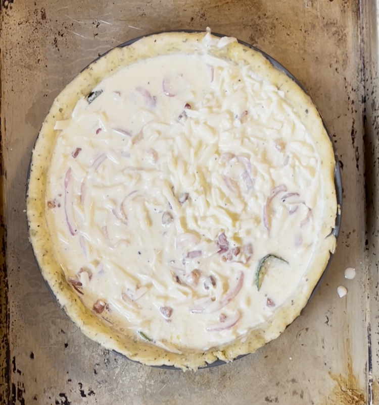Image of Using your hands or a spatula, gently mix the contents together, ensuring that the custard fills every crevice and the filling is evenly dispersed throughout the pie crust.