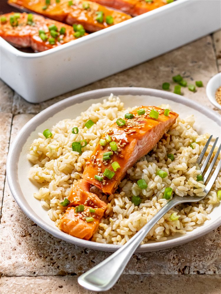 Image of Remove from oven and spoon sauce over salmon. Top with...