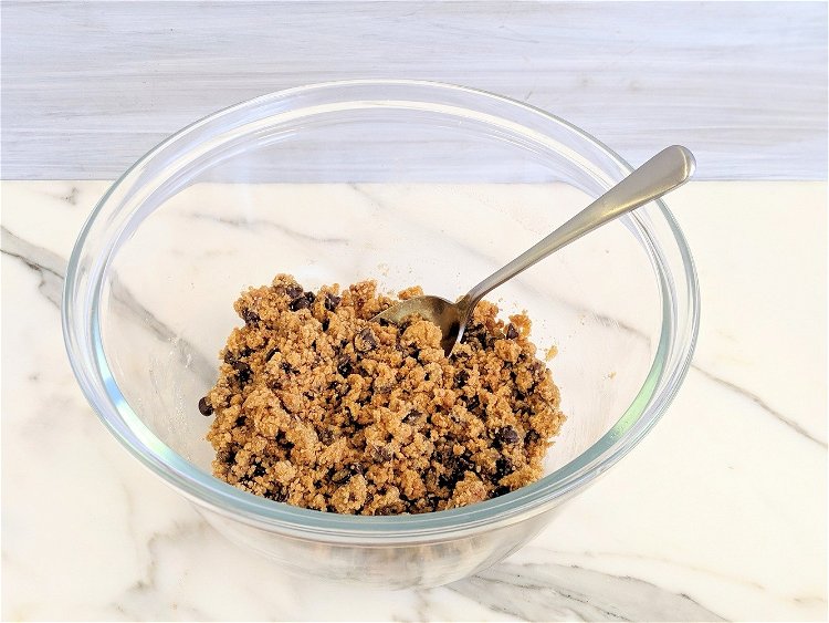 Image of Using a spoon combine the ingredients until it appears crumbly.