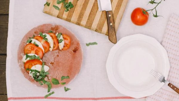 Image of Layered Caprese Salad with Balsamic and Olive Oil on a Salt Block