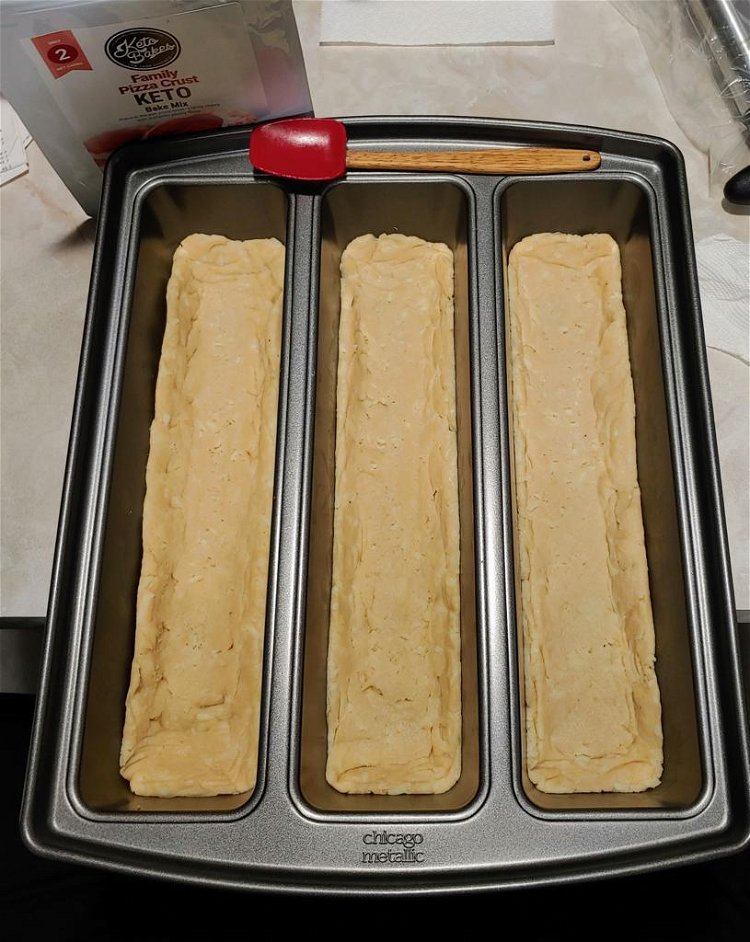 Image of Spread the dough into 3 equal sections of a shallow...