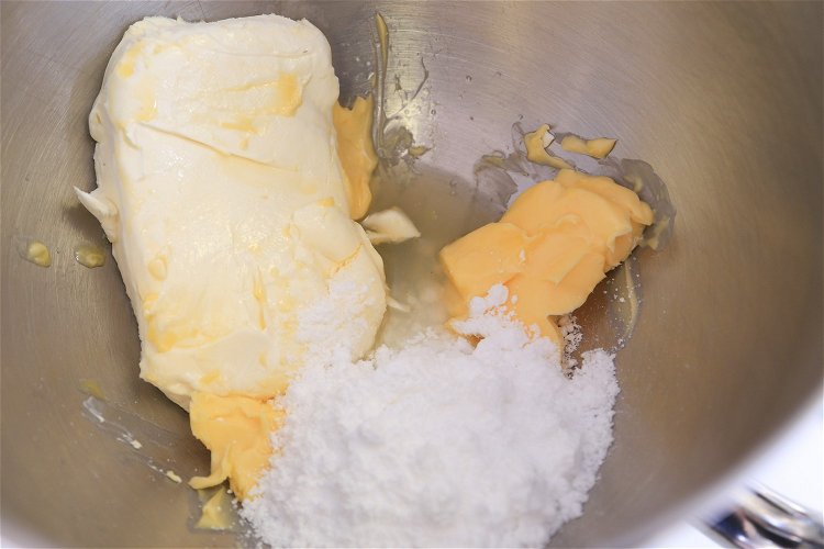Image of Place cream cheese, butter, icing mix and lemon juice in...