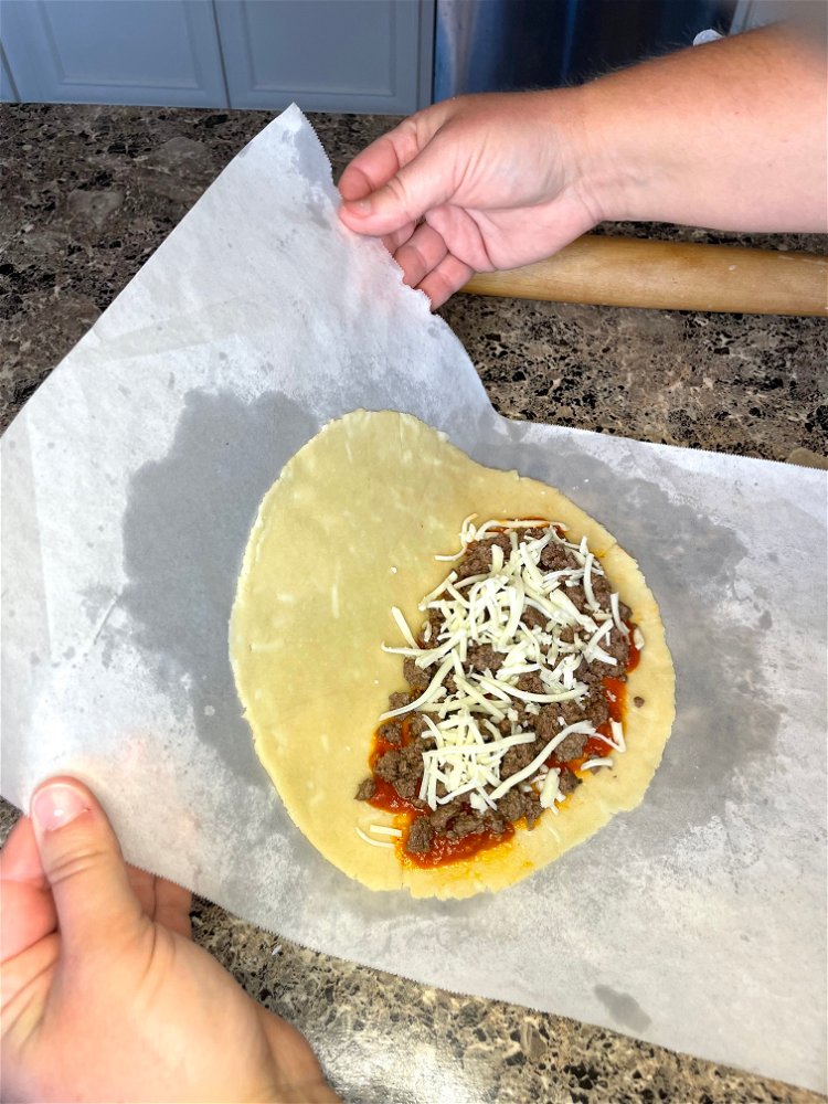 Image of Spread ¼ cup marinara sauce onto half of each piece...