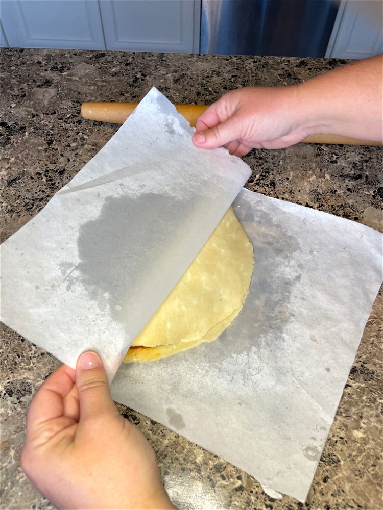 Image of Fold in half, holding onto the edges of the parchment...